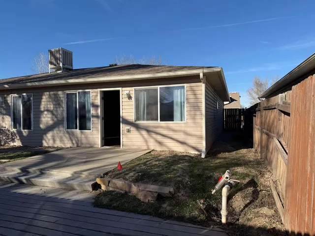 a view of a house with backyard and deck