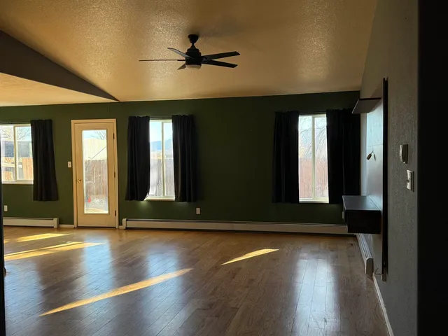 a view of room with window and wooden floor