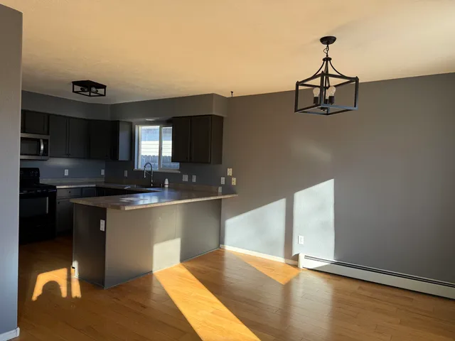a kitchen with stainless steel appliances granite countertop a sink and cabinets