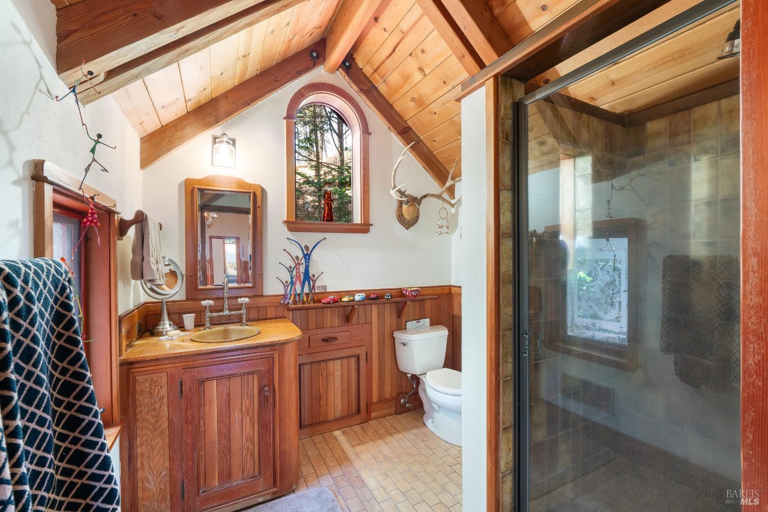 4034 Spring Mountain Road St. Helena, CA 94574 - Photo 20 of 36 a bathroom with a granite countertop sink a mirror and shower