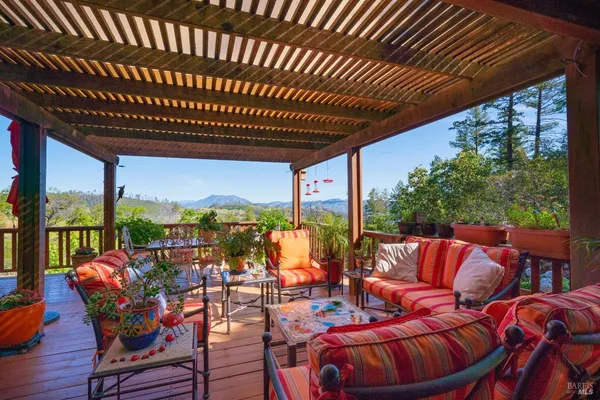 a view of a chairs and table in patio with a swimming pool