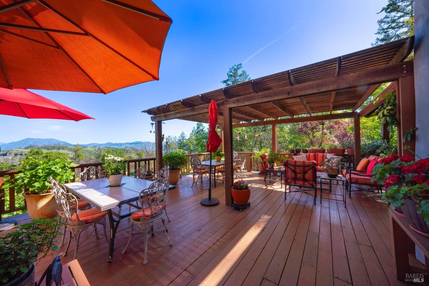 4034 Spring Mountain Road St. Helena, CA 94574 - Photo 27 of 36 a view of a patio with lawn chairs and wooden floor