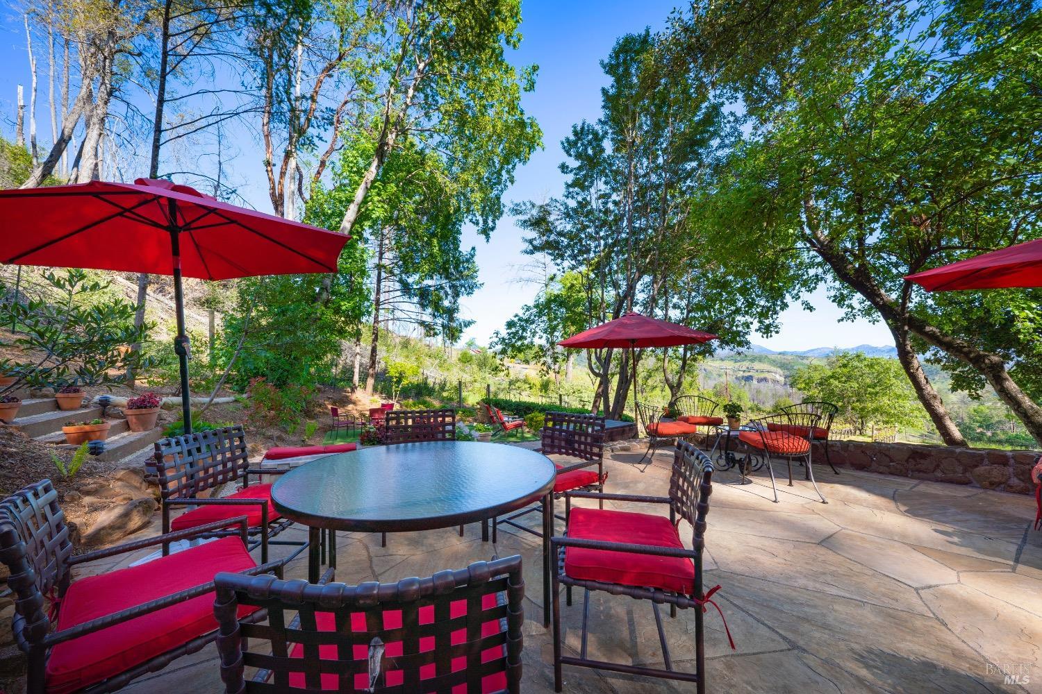 4034 Spring Mountain Road St. Helena, CA 94574 - Photo 28 of 36 an outdoor sitting area with furniture and umbrella