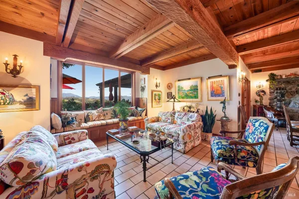 a living room with furniture and a floor to ceiling window