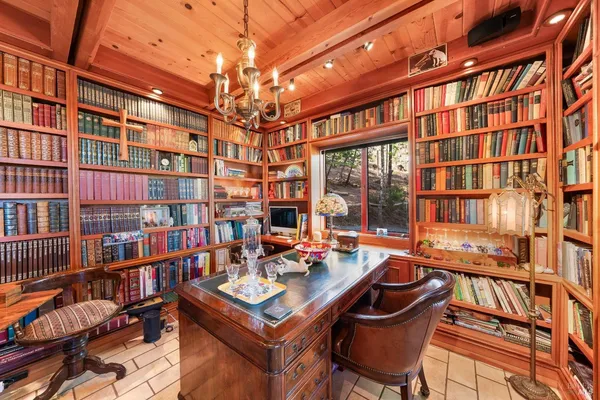 a work room with furniture and a book shelf