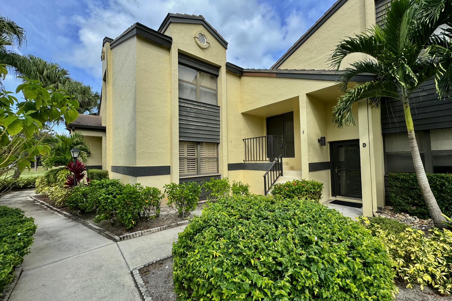 3991 Southwest Greenwood Way, Unit I Palm City, FL 34990 - Photo 2 of 15 front view of a house with a small yard