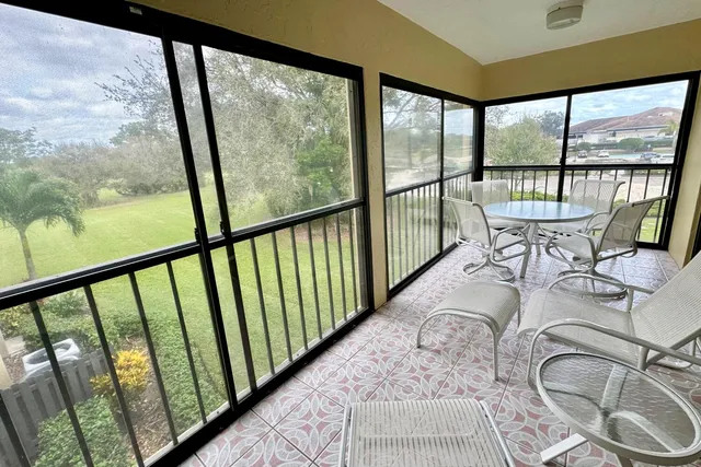 a view of a city from a balcony with furniture