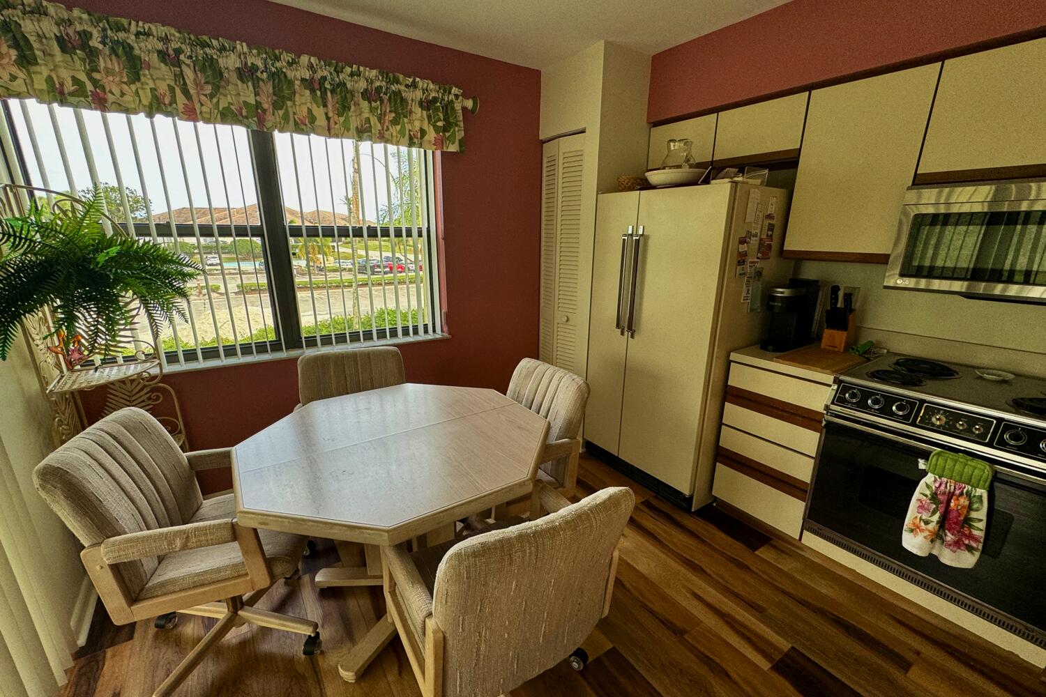 3991 Southwest Greenwood Way, Unit I Palm City, FL 34990 - Photo 10 of 15 a kitchen with a table chairs and refrigerator