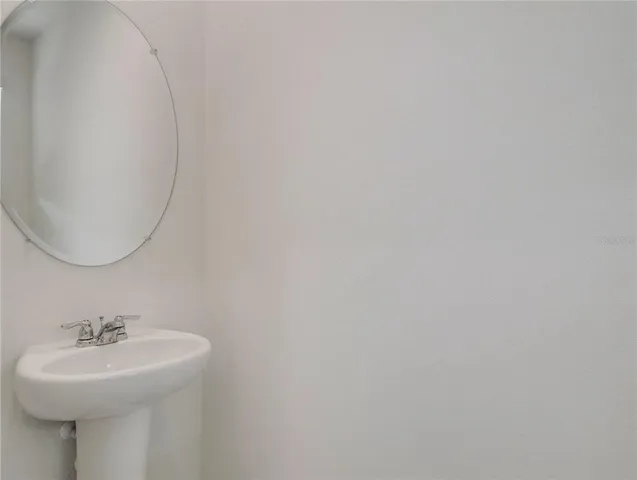 a bathroom with a sink a mirror and vanity