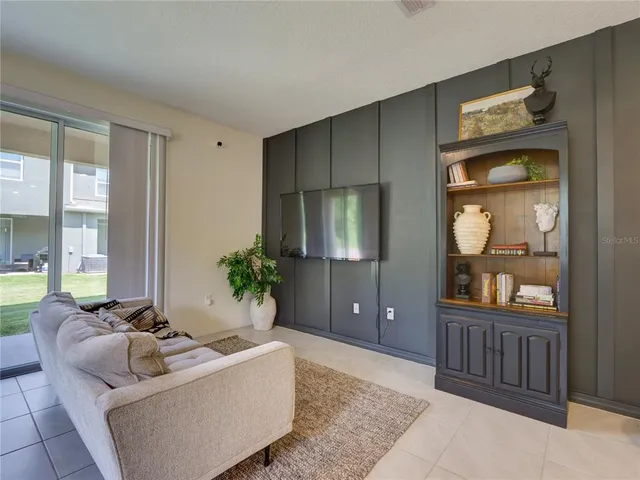 a living room with furniture and large windows