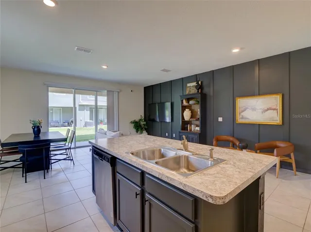 a kitchen with kitchen island a sink table and chairs