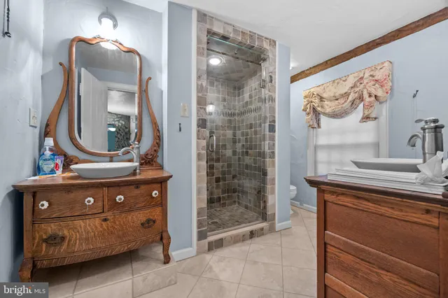 a bathroom with a sink a mirror and a shower