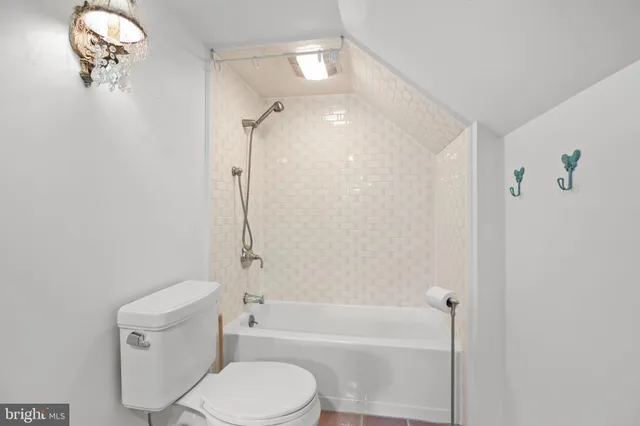 a bathroom with a toilet and a bathtub