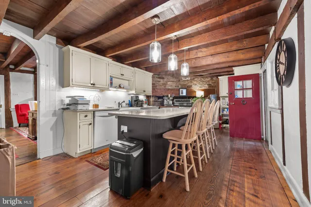 a kitchen with a sink a cabinets and appliances