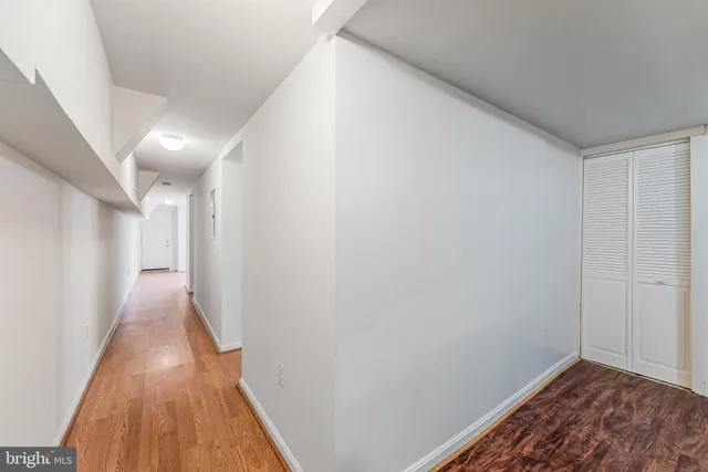 a view of hallway with wooden floor