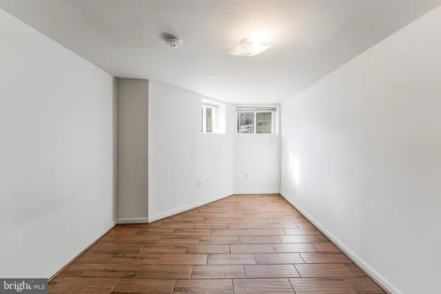 a view of an empty room with wooden floor