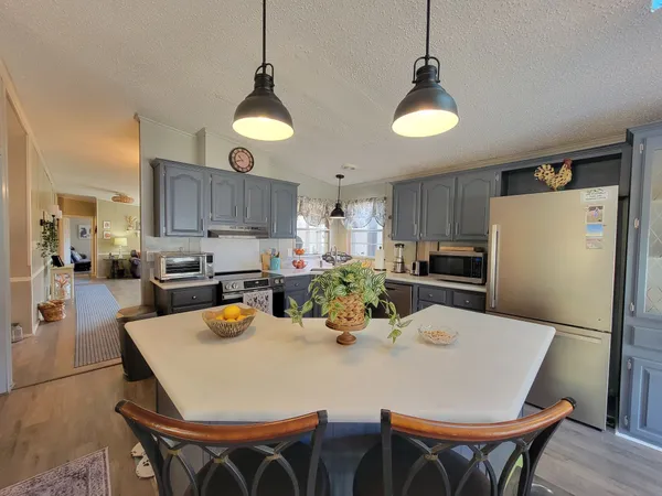 a kitchen with cabinets and wooden floor