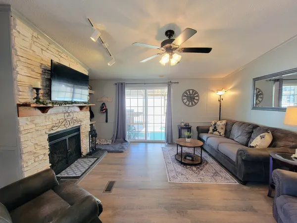 a living room with furniture a fireplace and a flat screen tv