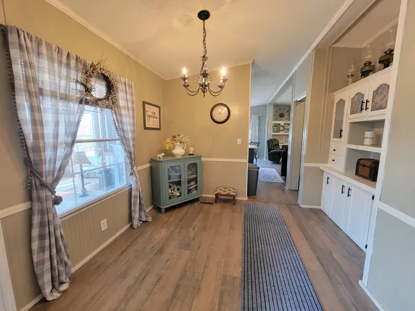 a living room with furniture a fireplace and a floor to ceiling window