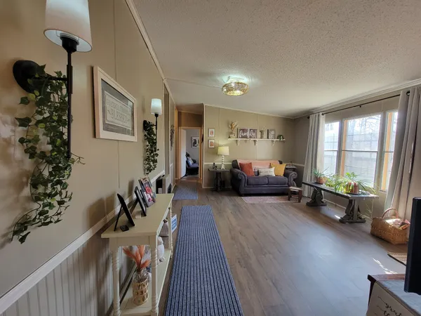 a living room with furniture and a floor to ceiling window
