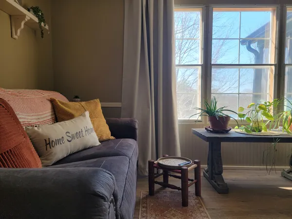a living room with furniture fireplace and a large window