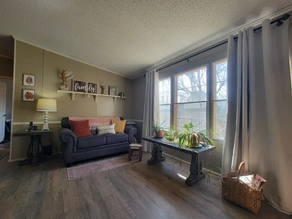 a spacious bedroom with a large bed and a chandelier