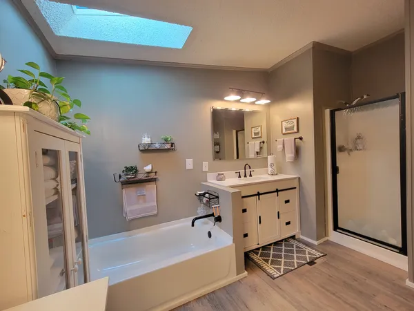a bathroom with a double vanity sink toilet and shower