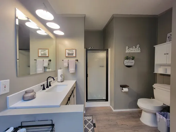 a spacious bathroom with a granite countertop sink and a mirror