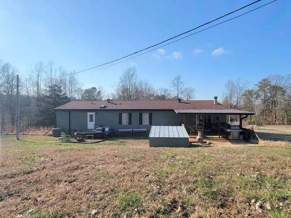 a view of a backyard with plants and outdoor seating