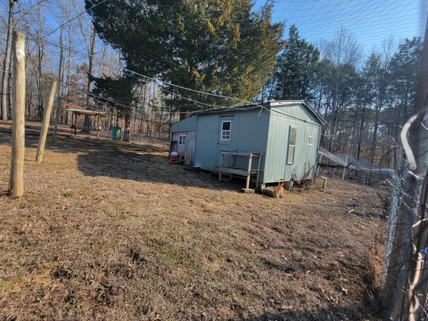 a view of a yard with wooden fence