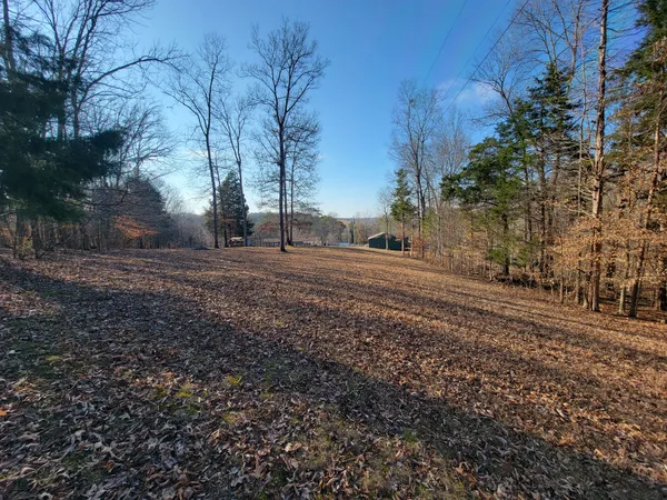 a backyard of a house with barbeque oven table and chairs