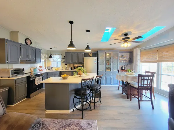 a living room with stainless steel appliances kitchen island granite countertop furniture and a kitchen view