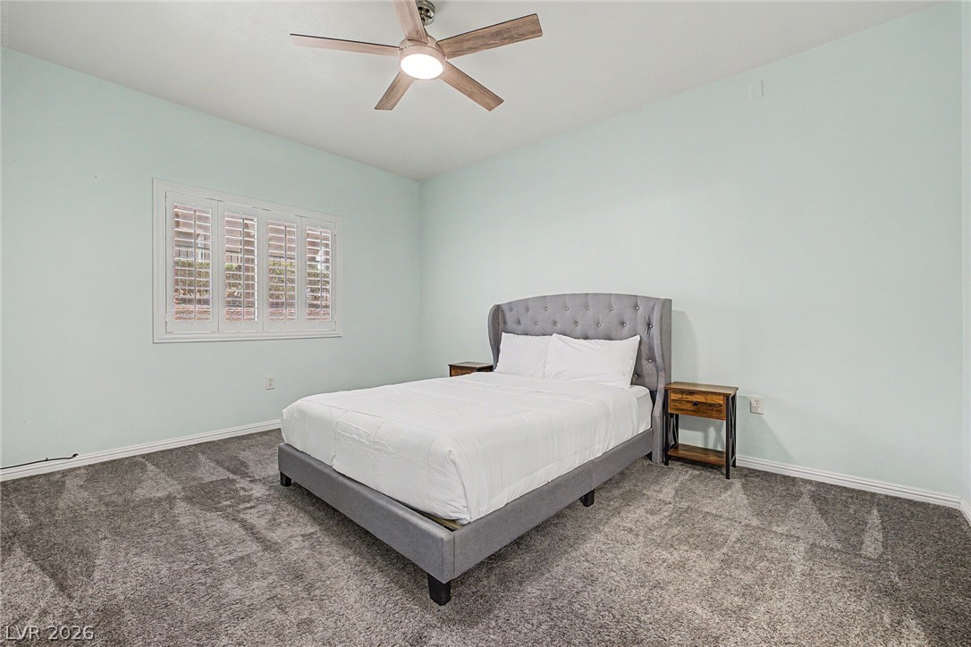 2153 Quarry Ridge Street, Unit 103 Las Vegas, NV 89117 - Photo 4 of 42 Plush carpeting and a window with plantation shutters create a tranquil and comfortable bedroom retreat.