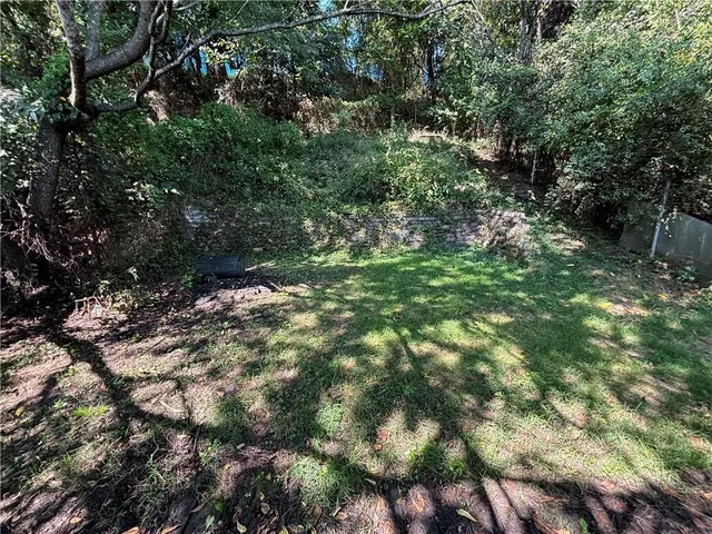 a view of house with a yard