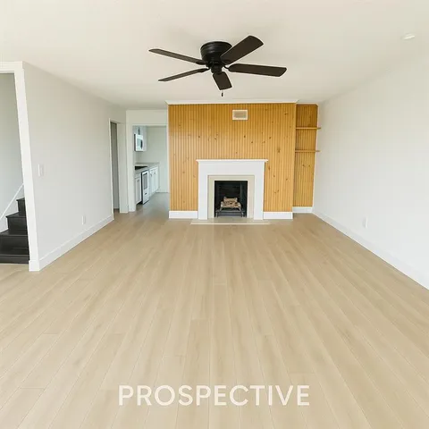 a view of an empty room with a fireplace