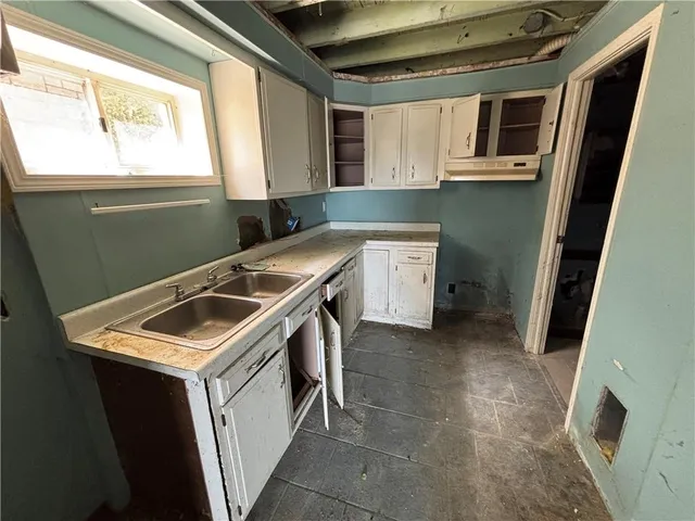 a utility room with sink dryer and washer
