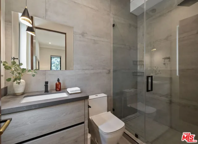 a bathroom with a toilet sink and shower