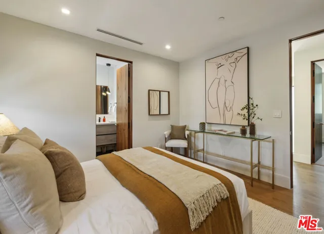 a bedroom with a bed and a mirror