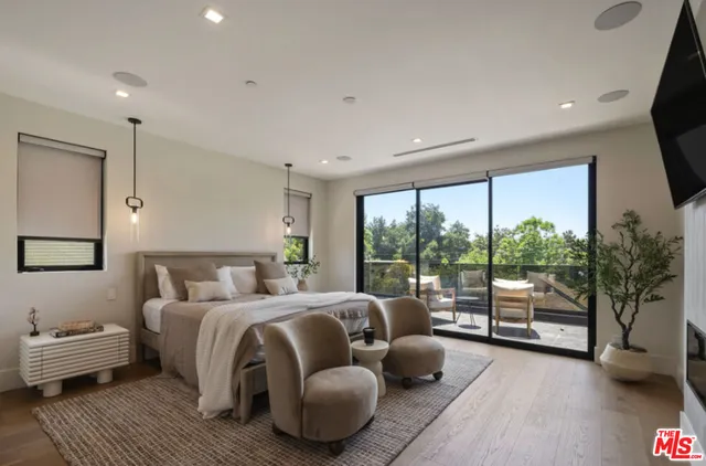 a bedroom with furniture and a large window