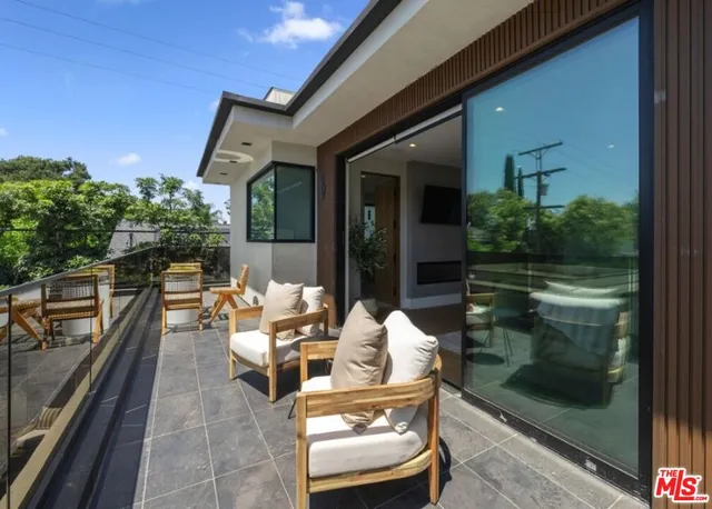a outdoor space with lots of white furniture and shower
