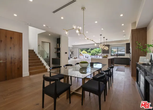 a dining room with furniture and wooden floor