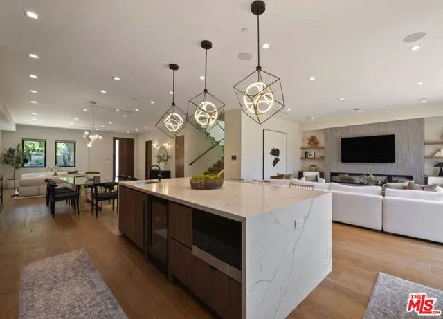 a large kitchen with lots of counter space a sink appliances and a couch