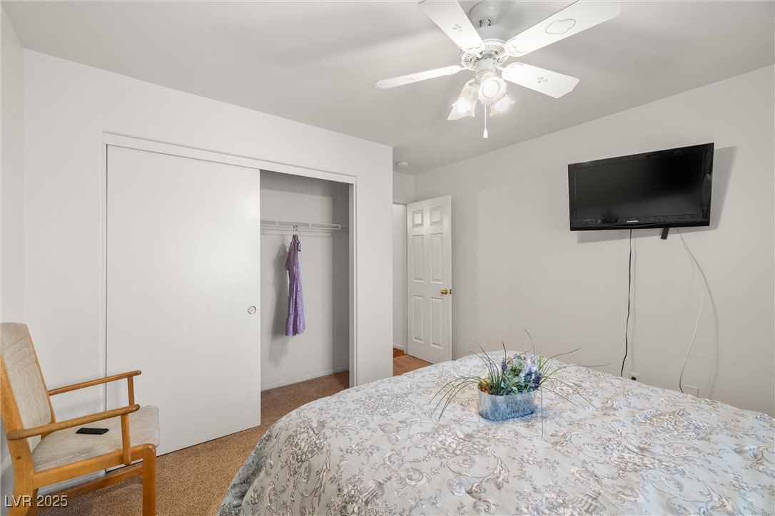 81 Diamond Bar Road Pahrump, NV 89048 - Photo 20 of 38 Carpeted bedroom featuring a closet and ceiling fan