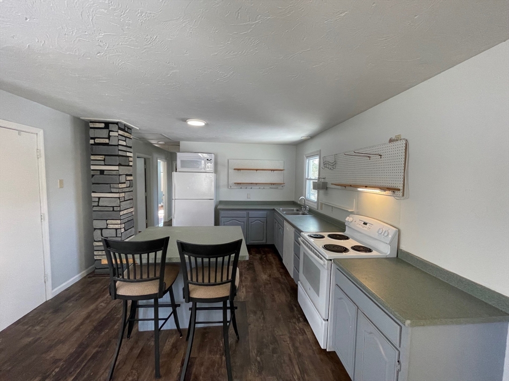 35 Ellis Road Southbridge, MA 01550 - Photo 5 of 29 a kitchen with a table chairs and a stove