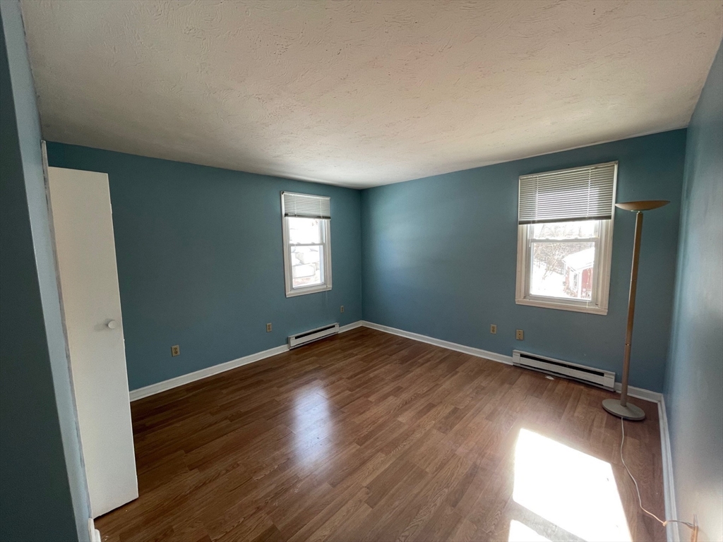 35 Ellis Road Southbridge, MA 01550 - Photo 7 of 29 an empty room with wooden floor and windows
