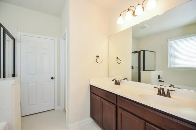 a bathroom with a double vanity sink mirror and