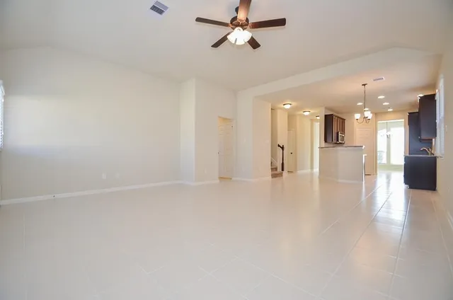 wooden floor in an empty room with a kitchen
