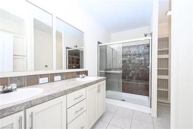 a bathroom with a granite countertop sink mirror and double