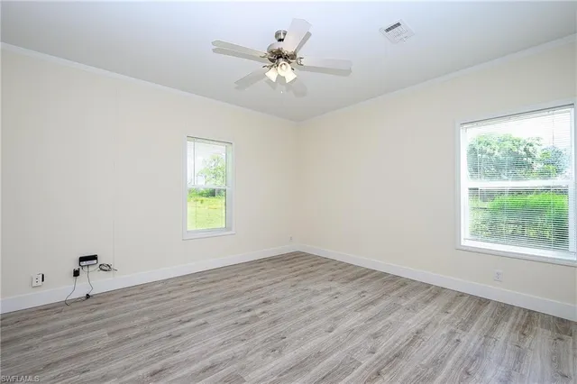 wooden floor in an empty room with a window