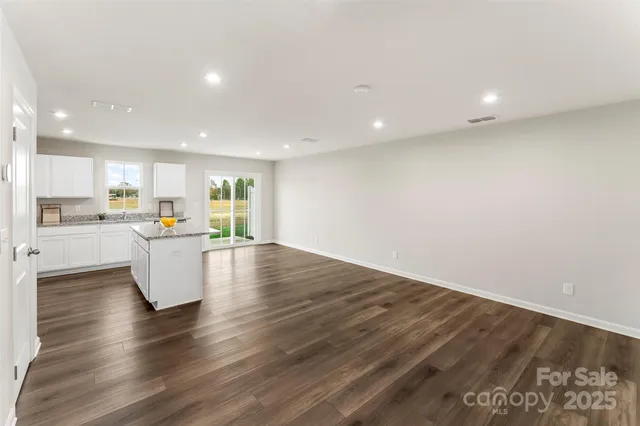 a view of kitchen with kitchen island and stainless steel appliances